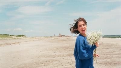Girl on Beach with Flowers